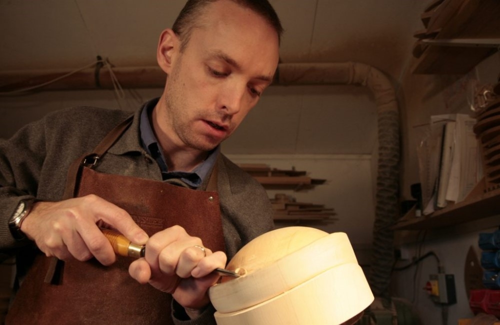 Owen Morse-Brown carves wooden hat blocks.