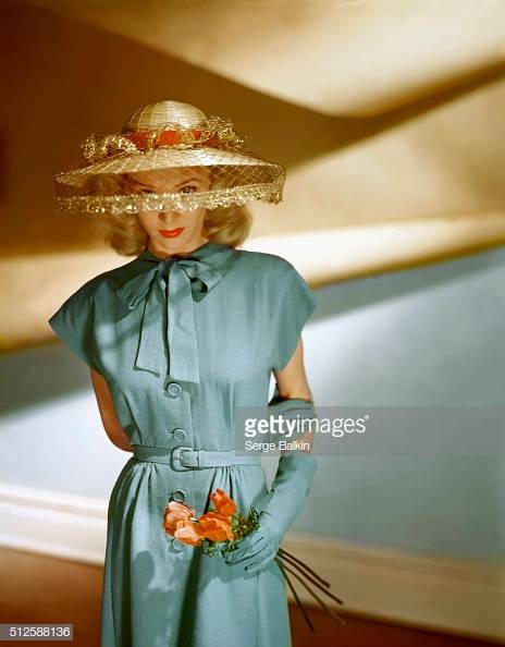 Actress Carole Landis wearing blue short-sleeve dress, a Vogue pattern, together with matching gloves and John Frederics veiled hat. (Photo by Serge Balkin/Condé Nast via Getty Images)