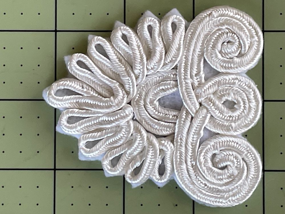 Soutache felt patch for attaching ostrich feathers to historical hats.